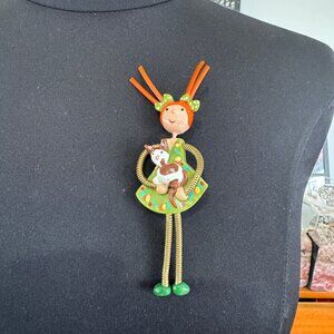 Whimiscal Brooch Pin 1990s Moveable legs Girl holding a puppy Sharon Roslund